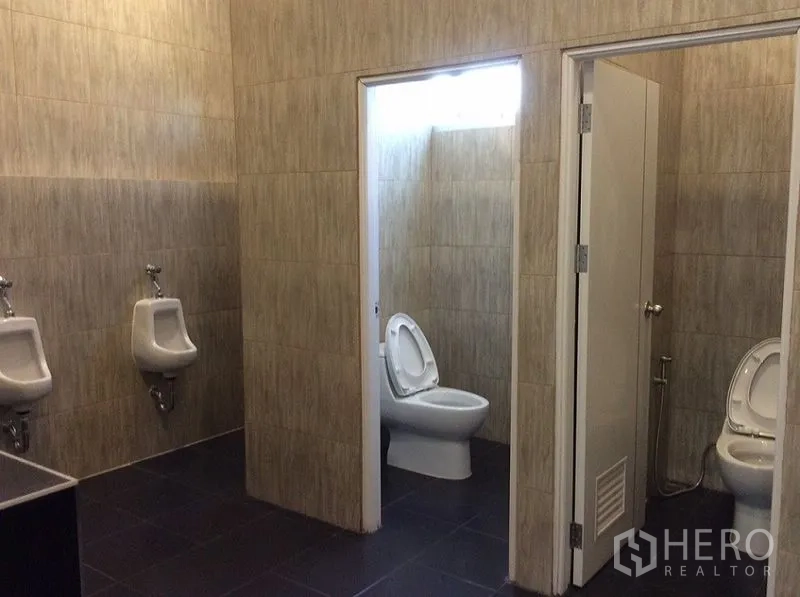 Factory for sale in Bang Sao Thong, Samut Prakan - Clean tiled restrooms with separate cubicles, toilets and urinals.