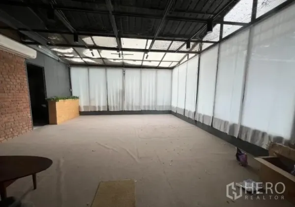 Retail Space for rent in Watthana, Bangkok - Open-plan interior with a glazed roof, curtain-lined windows and a brick accent wall.