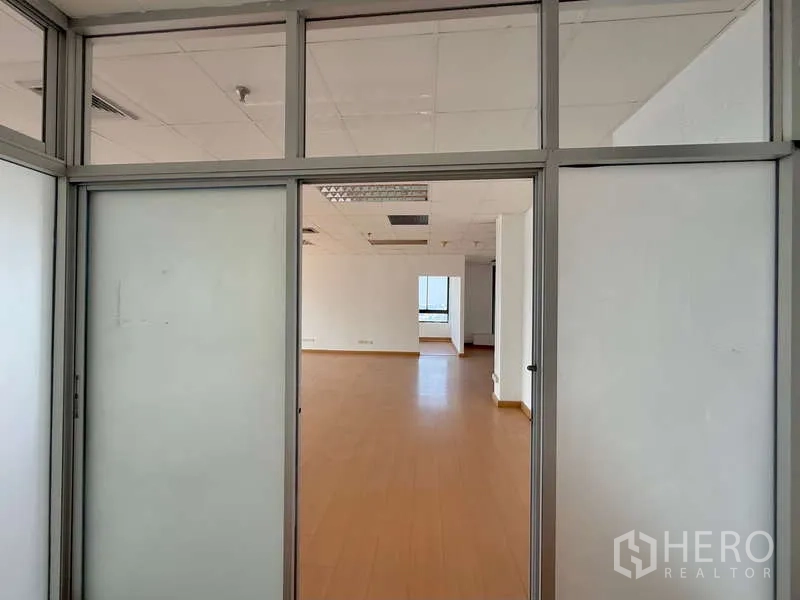 Office Space for rent in Chatuchak, Bangkok - View through sliding glass doors into a bright open-plan office.