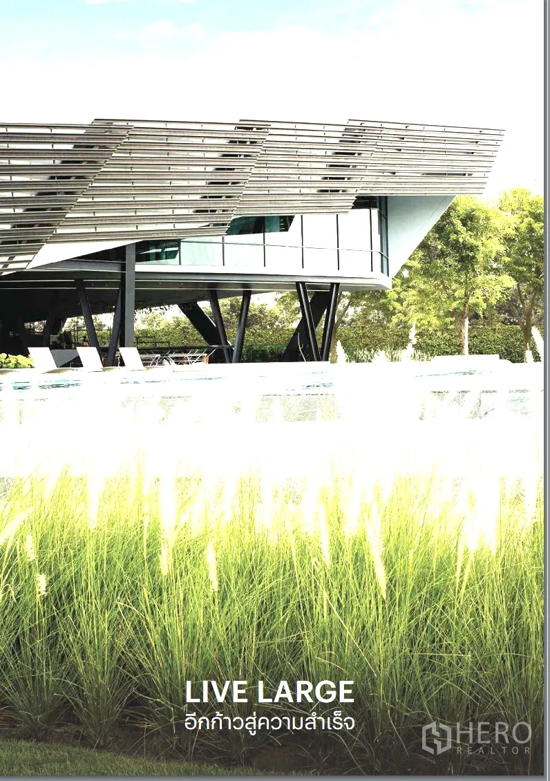 Detached House for rent or sale in Pathum Thani - Modern clubhouse pavilion raised over the pool with lush landscaping.