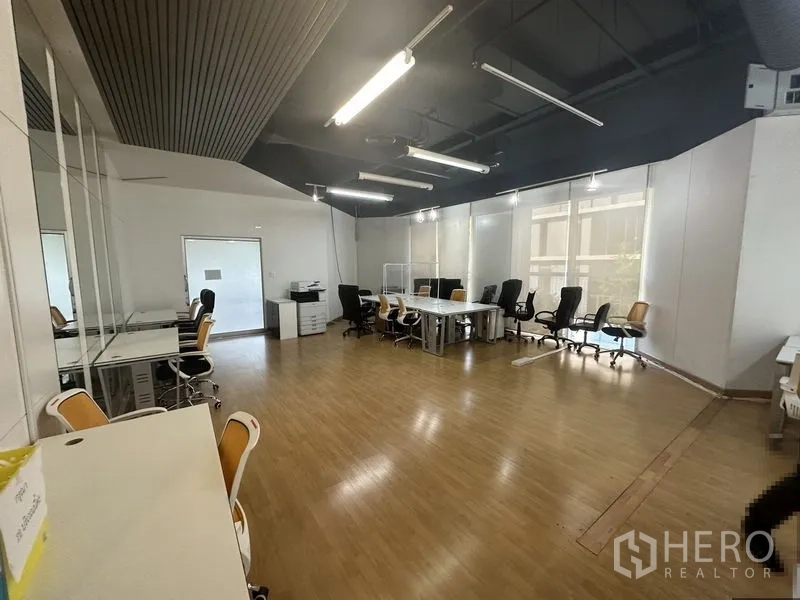 สำนักงาน ให้เช่าในPathum Wan, Bangkok - ที่นั่งทำงานเรียงตามหน้าต่างบานกว้าง ในออฟฟิศเพดานเปลือยสว่างโล่ง