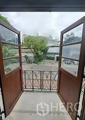 Retail Space for rent in Bangkok - Small balcony with double wooden doors and metal railing overlooking the front court.