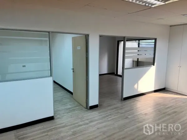 Office Space for rent in Pathum Wan, Bangkok - Partitioned office area with interior windows and doors, natural light and laminate flooring.
