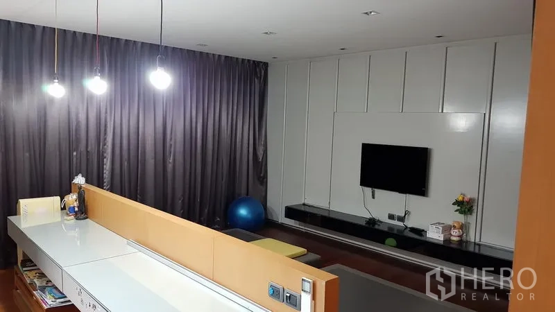 Home Office for sale in Wang Thonglang, Bangkok - Cozy media lounge with TV wall, long workstation and pendant lighting