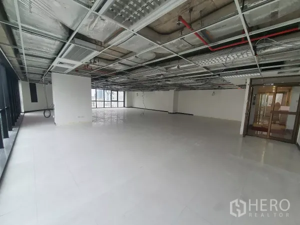 Office Space for rent in Bang Rak, Bangkok - Spacious office floor plate with glass entry doors and open ceiling services.