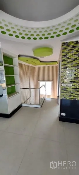 Home Office for sale in Wang Thonglang, Bangkok - Landing with green accents, shelving and stairwell.