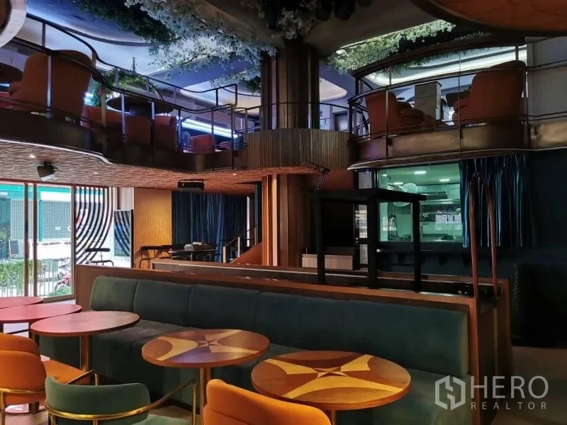 Retail Space for rent - Ground floor lounge facing tall windows, showcasing a mezzanine and feature column.