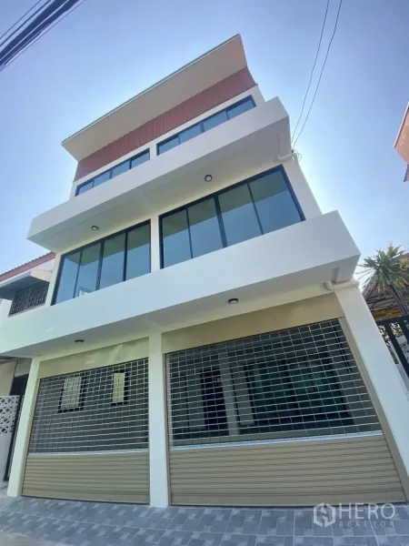 Home Office for sale - Modern multi-storey home office facade with wide windows and dual roller shutters in Watthana, Bangkok.