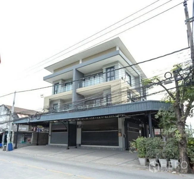 Home Office for rent in Bang Khen, Bangkok - Street-facing three-storey modern home office with balconies and multiple roller doors.