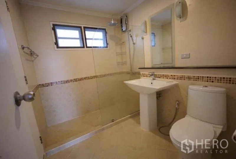 Detached House for rent in Bang Phli, Samut Prakan - Shower bathroom with glass enclosure, rain shower and mosaic border tiles.