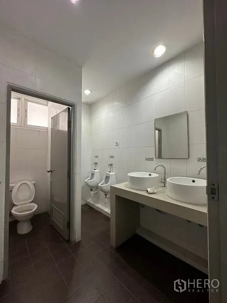 Warehouse for rent in Phra Nakhon Si Ayutthaya - Clean tiled restroom with twin basins, urinals and toilet cubicle.