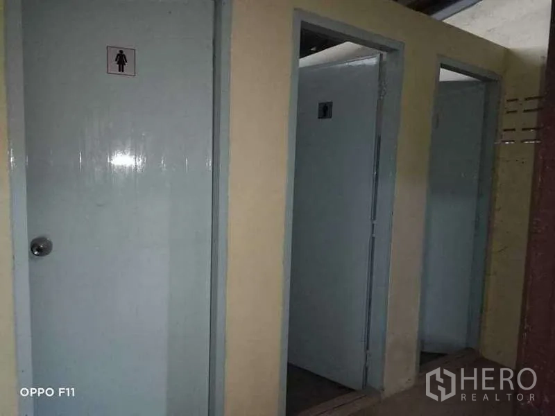 Warehouse for rent or sale in Mueang Samut Sakhon, Samut Sakhon - Row of separate restroom stalls with light gray doors.