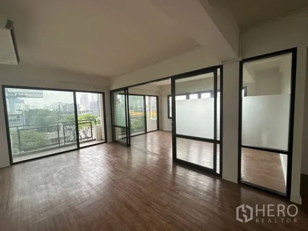 Office Space for rent in Sathon, Bangkok - Bright open-plan office with wood floors, glass partitions and a balcony with city views in Sathon.