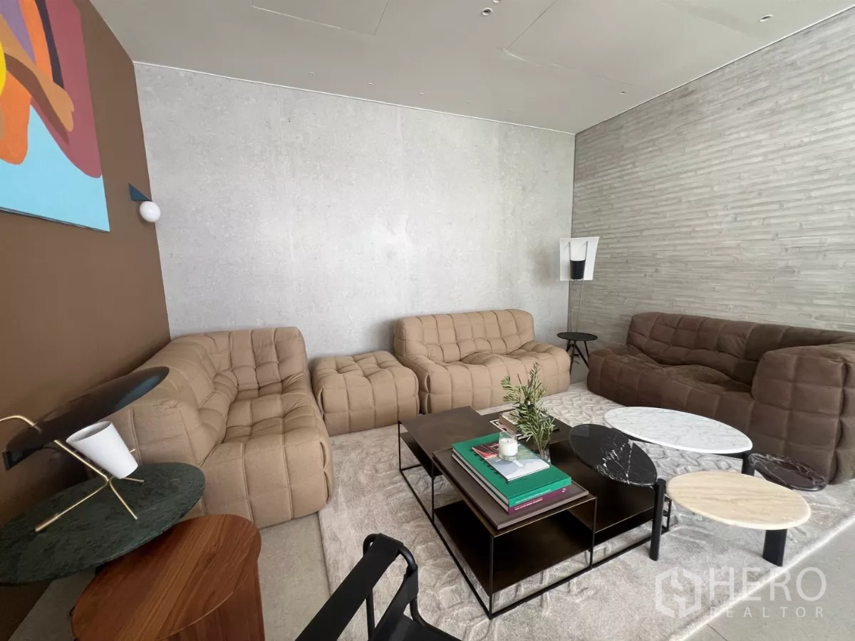 Retail Space for rent - Showroom room with tufted sofas and nesting marble tables.