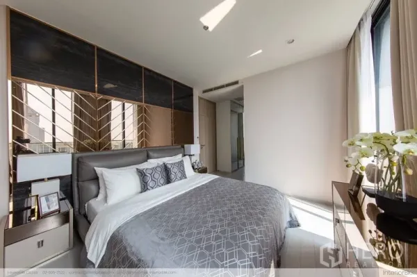 Condominium for rent in Pathum Wan, Bangkok - Sunlit bedroom with upholstered headboard, patterned feature wall and full-height windows.