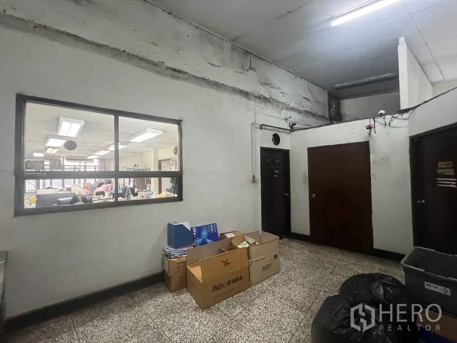 Shophouse for rent - Common area with storage boxes, windows and multiple doors.