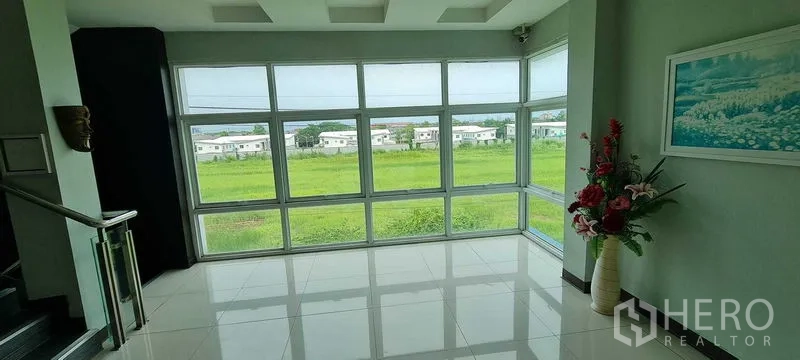 Warehouse for rent or sale in Bang Phli, Samut Prakan - Executive office with large sectional sofa, blinds, and desk.