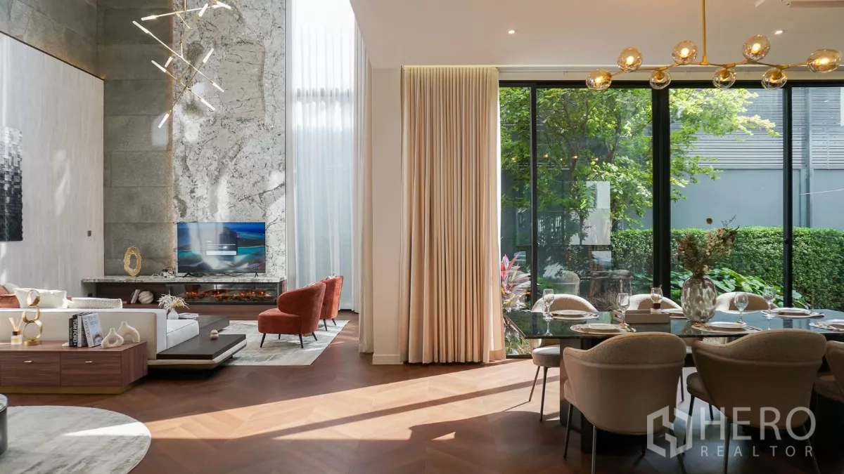 Detached House for rent or sale in Bang Kapi, Bangkok - Sunlit living and dining spaces connected to the garden through sliding glass doors.