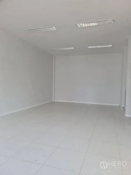 Factory for rent or sale in Lam Luk Ka, Pathum Thani - Clean white-tile room with fluorescent ceiling lights.