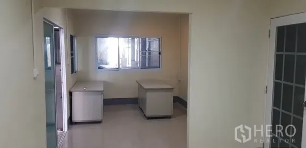 Warehouse for rent in Bang Phli, Samut Prakan - Internal office area with two desks, window and door connecting to the warehouse.