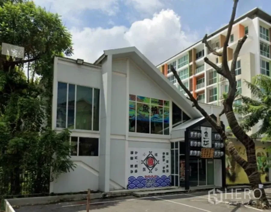 Retail Space for rent in Watthana, Bangkok - Front exterior of a two-storey standalone retail building with large windows and on-site parking.