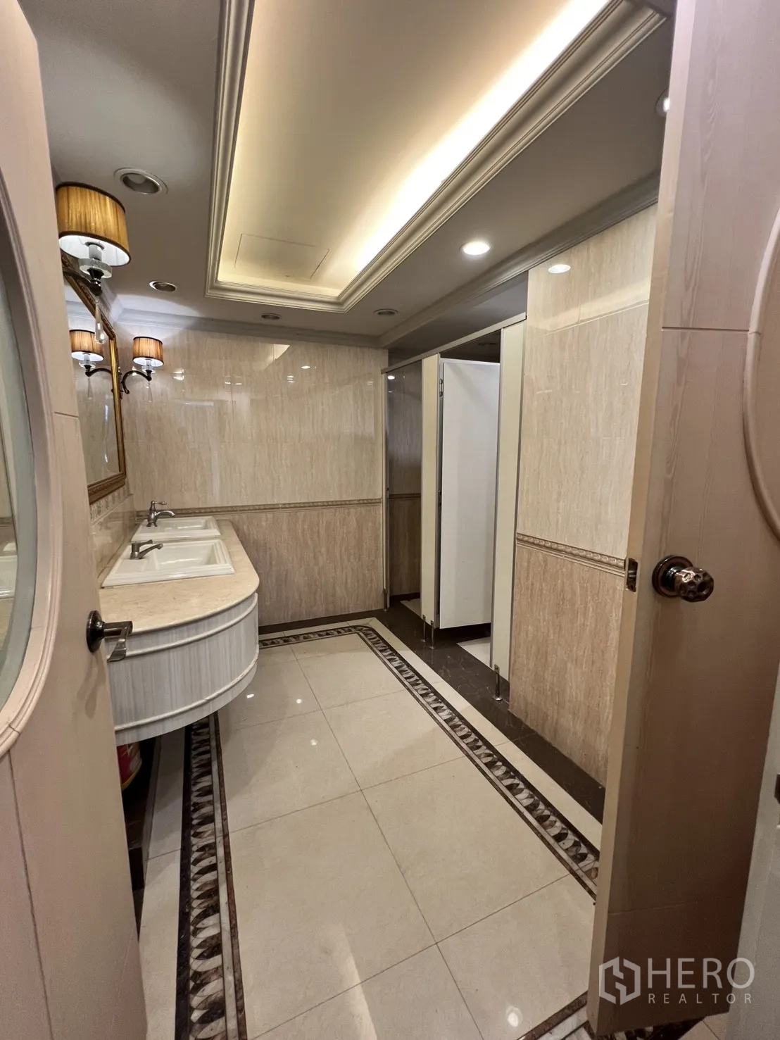 Office Space for rent in Watthana, Bangkok - Bathroom with double sinks, mirrors, and warm lighting.
