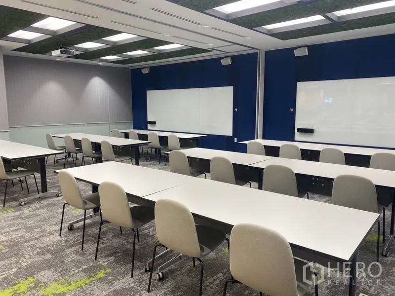 Office Space for rent in Pathum Wan, Bangkok - Training room set with rows of tables and chairs, large whiteboards and ceiling lights.