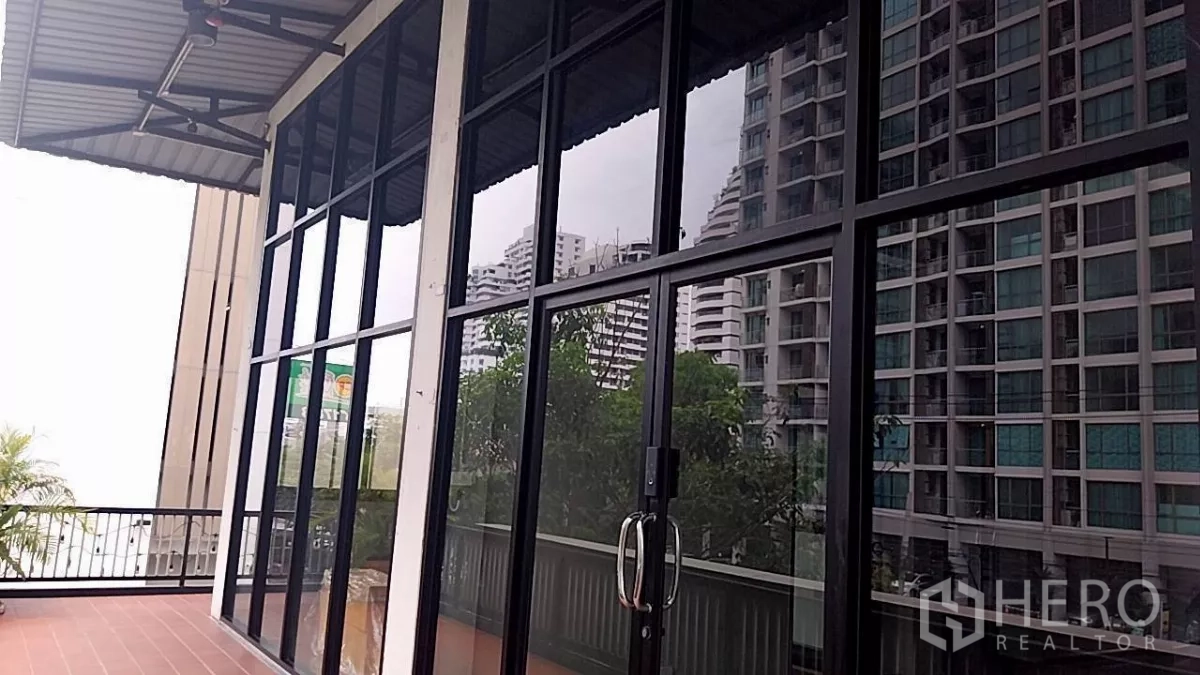 Retail Space for rent - Retail unit with floor-to-ceiling glass frontage and a terrace reflecting nearby condo towers.