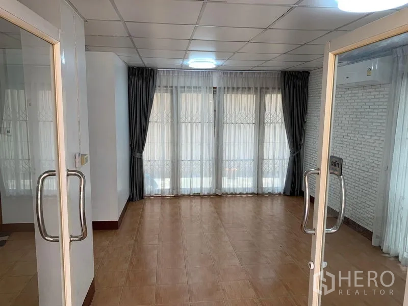 Office Space for rent in Chatuchak, Bangkok - Double glass doors opening to a bright office area with floor-to-ceiling windows.
