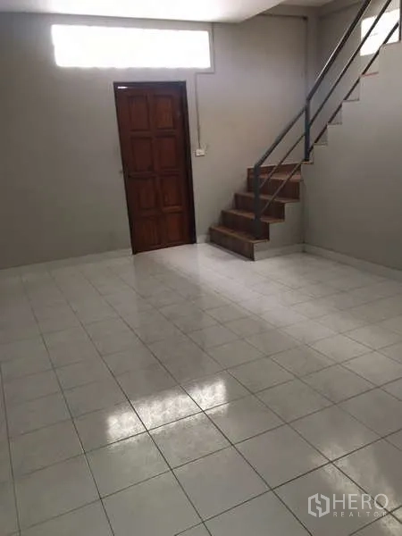Factory for rent in Bang Phli, Samut Prakan - Ground-floor office area with tiled floor, staircase and wooden door.