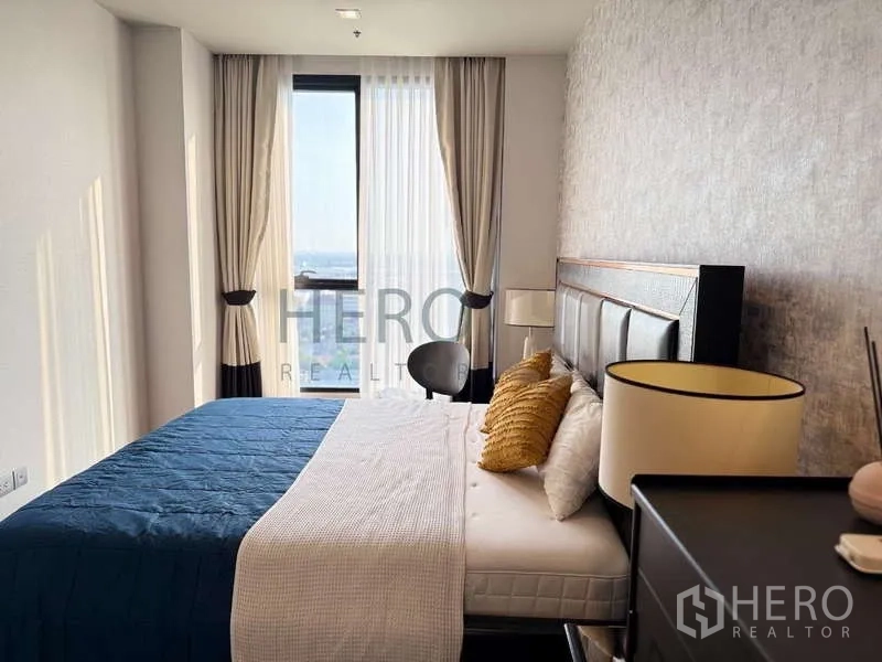 Condominium for rent - Bedroom view toward the window showing padded headboard and side tables.