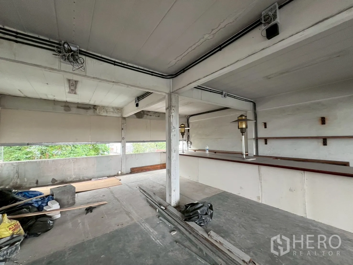 Retail Space for rent in Watthana, Bangkok - Open-plan fourth-floor retail space in Watthana with long service bar and strip windows over greenery.