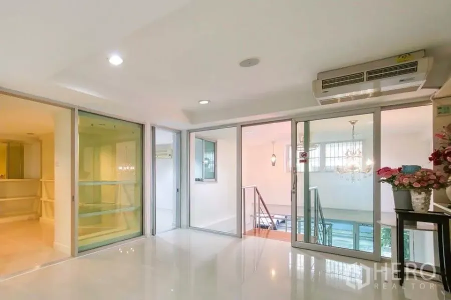 Office Space for rent in Khlong Toei, Bangkok - Bright landing with glass sliding doors, recessed lighting and wall-mounted air conditioner.