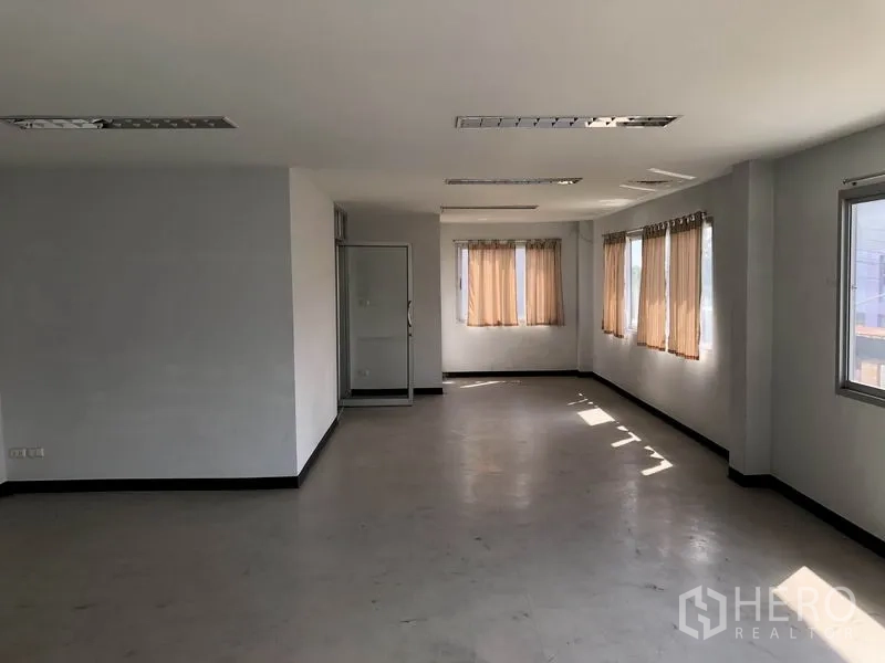 Factory for rent in Pathum Thani - Second-floor office room with windows, curtains and fluorescent lighting.