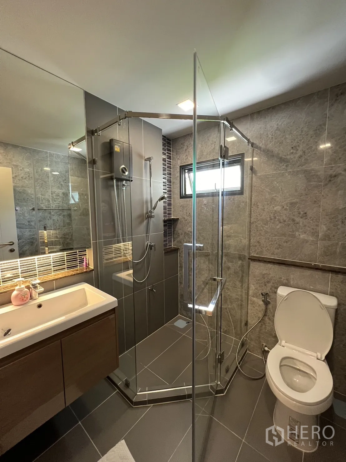 Detached House for rent or sale in Mueang Pathum Thani, Pathum Thani - Bright guest suite with bed by full-height windows and small bistro set.