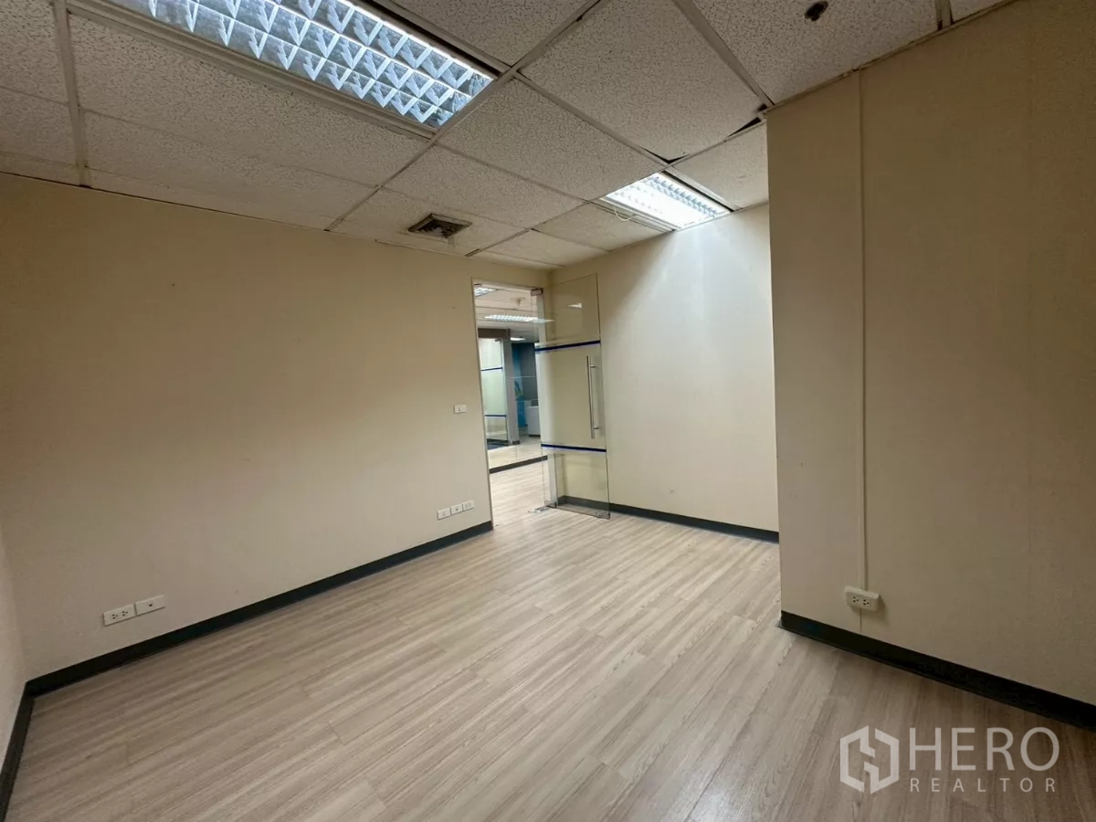 Office Space for rent in Watthana, Bangkok - Compact private office with laminate flooring, glass door and grid ceiling lighting.