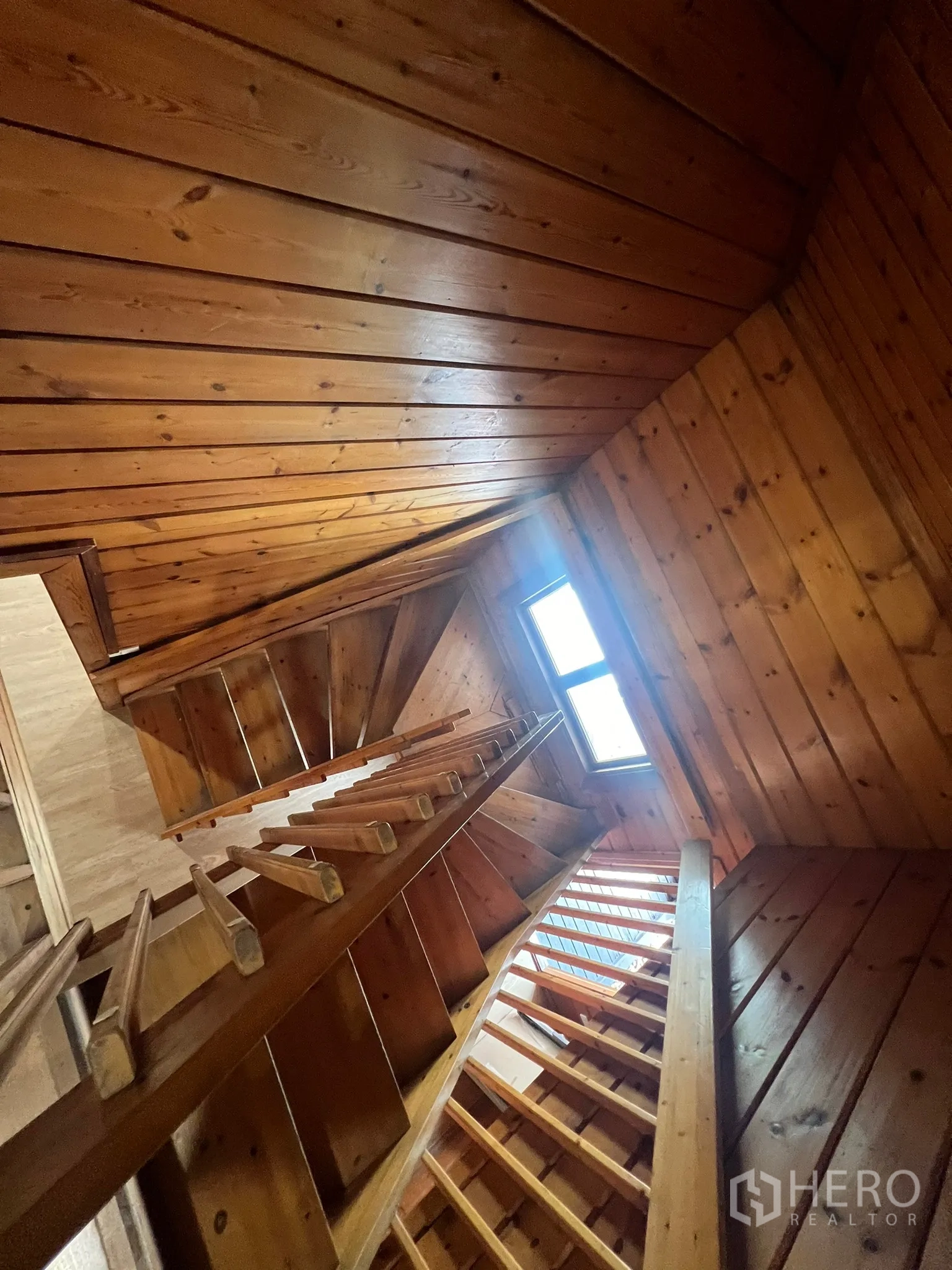 Home Office for rent in Suan Luang, Bangkok - Wooden staircase rising toward a skylight-style window under a timber ceiling.