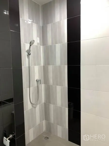 Home Office for rent or sale in Bang Na, Bangkok - Close-up of a tiled shower area with handheld shower set.