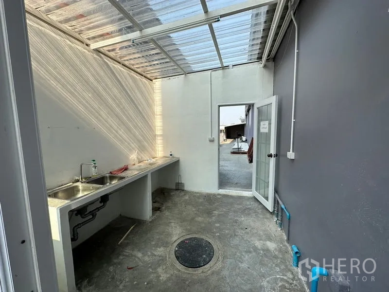 Factory for rent or sale in Lam Luk Ka, Pathum Thani - Outdoor wet pantry with twin sinks and a translucent roof.