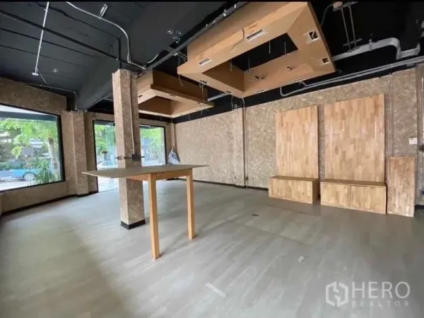 Retail Space for rent in Bang Rak, Bangkok - Open-ceiling shop interior with hanging wooden feature panels and large display windows.