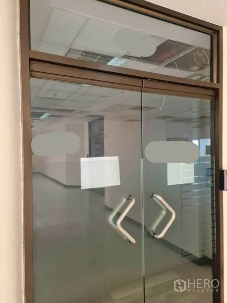Office Space for rent in Watthana, Bangkok - Double glass entry doors with metal pull handles and frosted decals to the office suite.