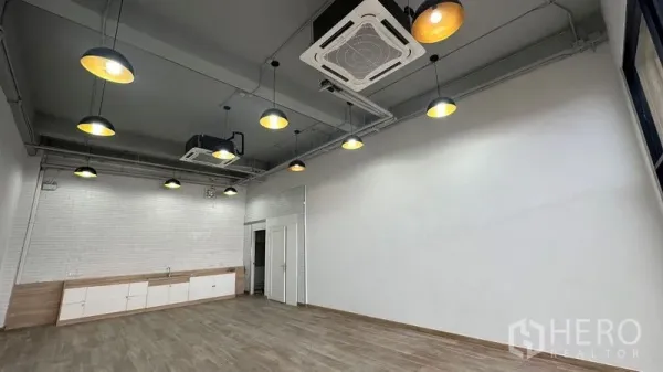 Retail Space for rent - High ceiling with pendant lights and cassette air-conditioning in the shop space.