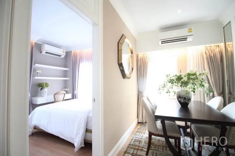 Detached House for rent or sale in Lat Phrao, Bangkok - Upstairs study nook with table and chairs next to a secondary bedroom.