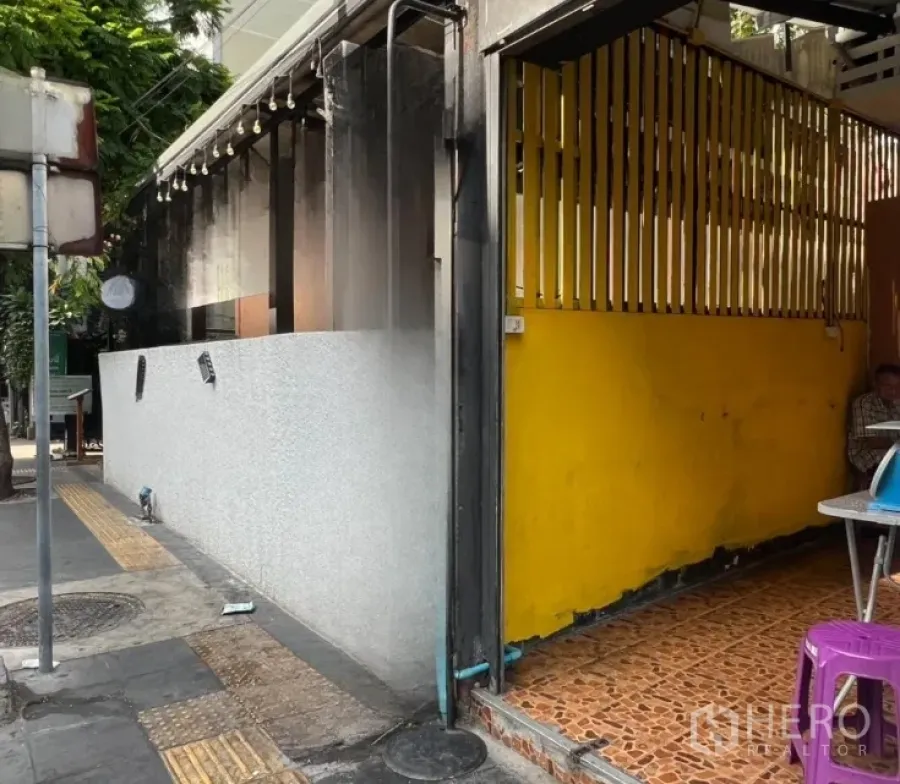 Retail Space for rent - Street-front retail unit with yellow facade and tiled entrance beside the sidewalk in Sukhumvit area.