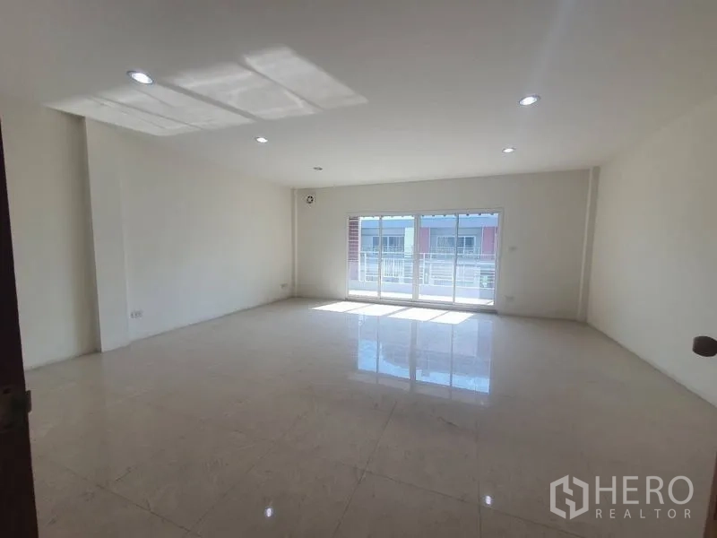 Home Office for rent or sale in Yan Nawa, Bangkok - Sunlit room with sliding doors opening to a balcony and polished flooring.