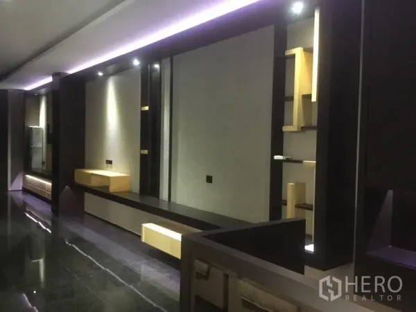 Home Office for rent in Suan Luang, Bangkok - Sleek interior corridor with built-in shelves, accent lighting and polished dark floors.