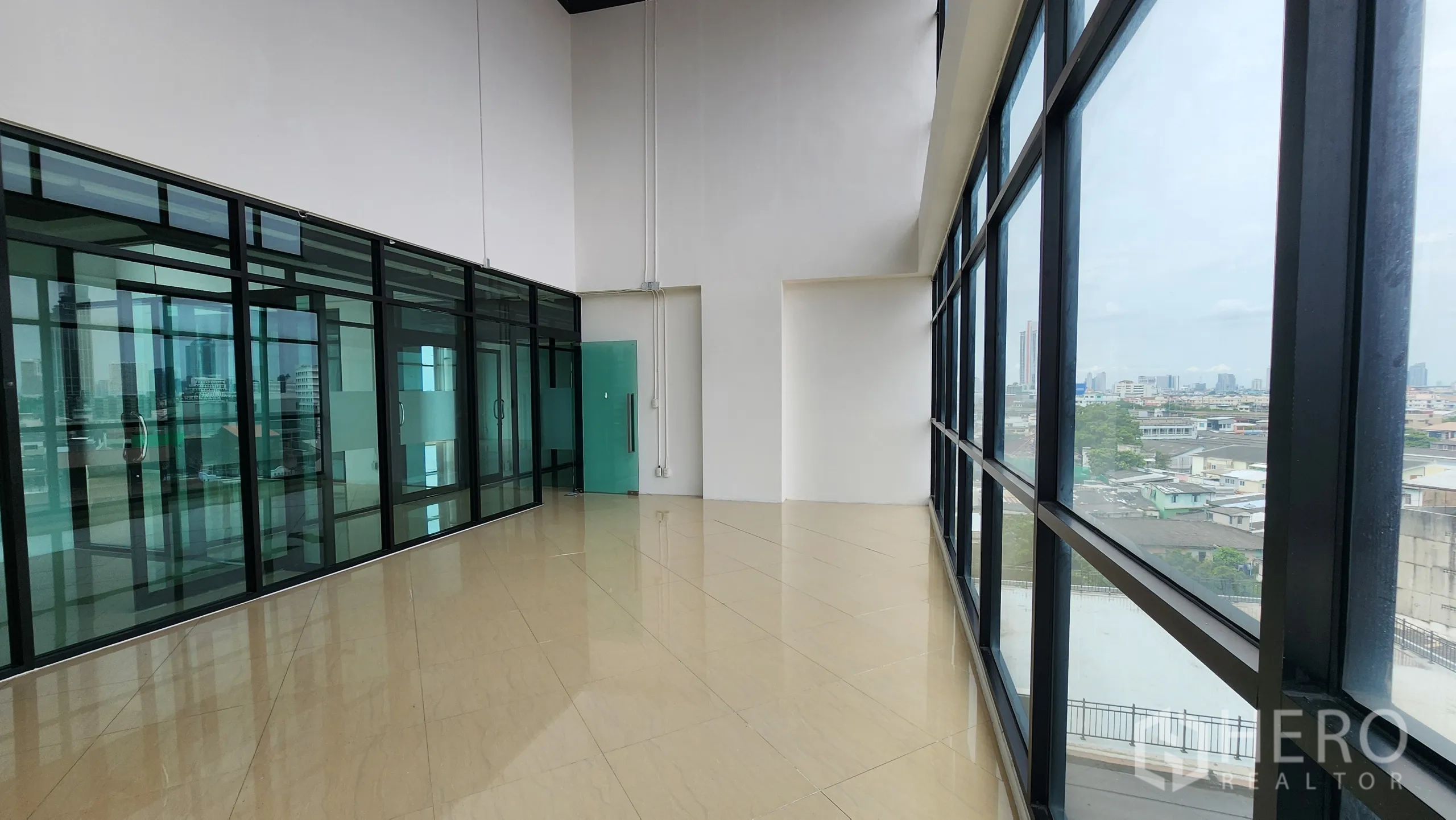 Office Space for rent in Yan Nawa, Bangkok - Long gallery-like office beside glass wall and floor‑to‑ceiling windows.