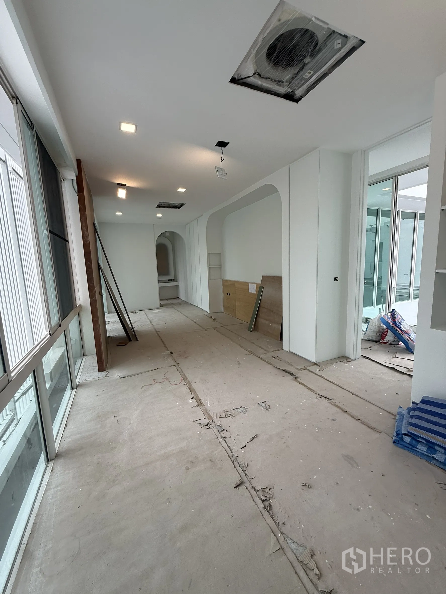 Detached House for sale in Bang Phli, Samut Prakan - Extended corridor with sliding windows and recessed ceiling lights.