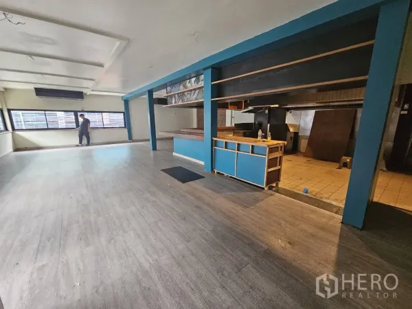 Retail Space for rent in Watthana, Bangkok - Open space with service counter and adjacent kitchen zone beside wall-to-wall windows.
