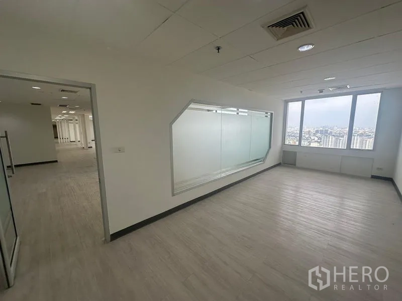 Office Space for rent - Private office showcasing an angular internal glass window and a big exterior window with city views.